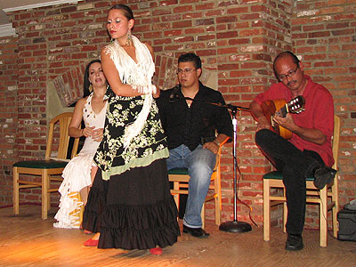 Flamenco dancers Sara Jerez and Ginette Perea in a black and green dress with white shawl, singer Hector Marquez and guitarist Miguelito at Las Tapas